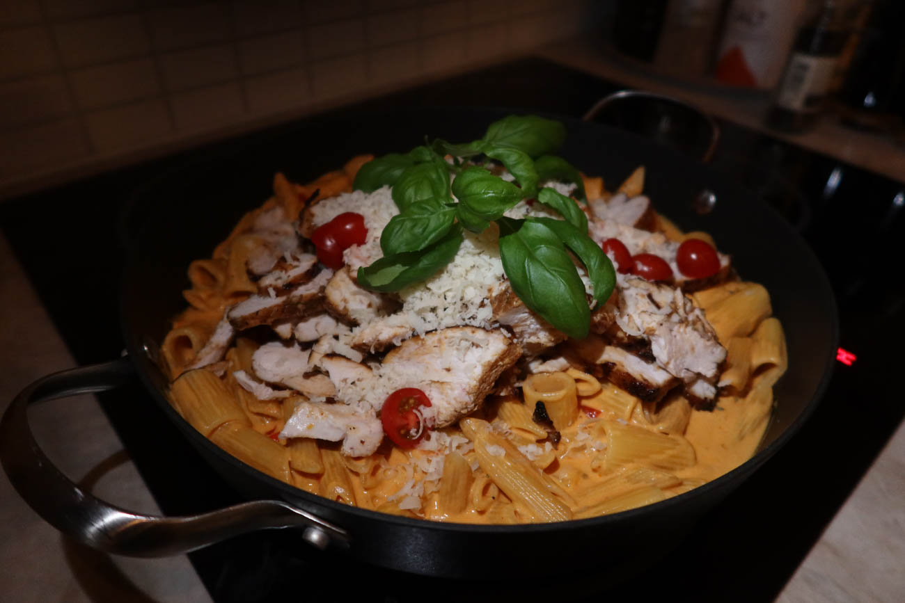 Närbild på pasta i krämig tomatsås med kyckling
